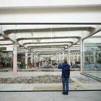 A visitor takes a photo at the Museum of Survivors, located in a factory where Oskar Schindler saved some 1,200 Jews during WWII, in Brnenec, Czech Republic, May 10, 2025. (AP Photo/Petr David Josek)