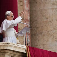 Pope Leo XIV appears at the central balcony of St. Peter's Basilica for his first Sunday blessing after his election, in St. Peter's Square at the Vatican, Sunday May 11, 2025. (AP Photo/Domenico Stinellis)
