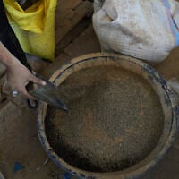 Displaced Palestinians purchase ground lentils as a substitute for making bread due to a shortage of flour in the Gaza Strip, in Khan Younis, May 11, 2025. (AP Photo/Abdel Karem Hanna)