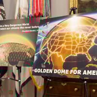 Posters for the proposed Golden Dome for America missile defense shield are displayed before an event with US President Donald Trump in the Roosevelt Room at the White House, May 12, 2025, in Washington. (AP Photo/Mark Schiefelbein)