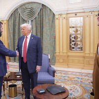 In this photo released by the Saudi Royal Palace, Syria's interim President Ahmad al-Sharaa, left, shakes hands with US President Donald Trump, center, in Riyadh, Saudi Arabia, May 14, 2025. At right is Saudi Crown Prince Mohammed bin Salman. (Bandar Aljaloud/Saudi Royal Palace via AP)