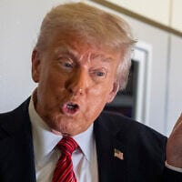 US President Donald Trump speaks to reporters aboard Air Force One en route from Riyadh, Saudi Arabia to Doha, Qatar, May 14, 2025. (AP Photo/Alex Brandon)