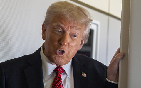 US President Donald Trump speaks to reporters aboard Air Force One en route from Riyadh, Saudi Arabia to Doha, Qatar, May 14, 2025. (AP/Alex Brandon)