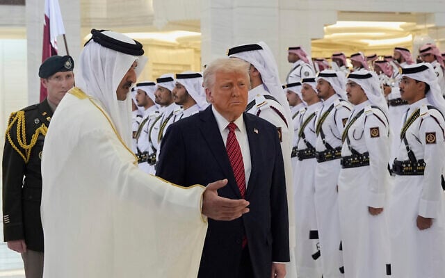 Qatar's Emir Sheikh Tamim bin Hamad Al Thani, left, welcomes US President Donald Trump during an official welcoming ceremony at the Amiri Diwan in Doha, Qatar, May 14, 2025. (AP Photo/Alex Brandon)