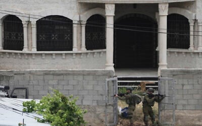 Israeli soldiers search a Palestinian village next to the West Bank settlement of Bruchin, the morning after a Palestinian gunman killed Tzeela Gez, who was on her way to the hospital to give birth, May 15, 2025. (AP /Maya Alleruzzo)