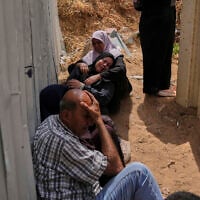 Palestinians mourn their relatives who were killed in Israeli airstrikes on a medical center in Jabalia, northern Gaza Strip, on Thursday, May 15, 2025. (AP Photo/Jehad Alshrafi)