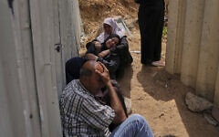 Palestinians mourn their relatives who were killed in Israeli airstrikes on a medical center in Jabalia, northern Gaza Strip, on Thursday, May 15, 2025. (AP Photo/Jehad Alshrafi)