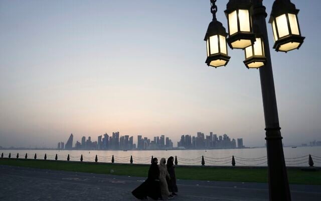 Three women walk along the Corniche at dusk, with the Doha skyline in the background, in Doha, Qatar, May 15, 2025. (Fatima Shbair/AP) Three women walk along the Corniche at dusk, with the Doha skyline in the background, in Doha, Qatar, May 15, 2025. (Fatima Shbair/AP)