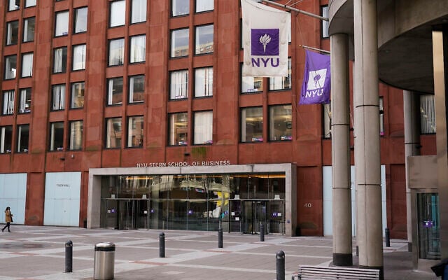 FILE - Pedestrians walk near an NYU building in New York, Dec. 16, 2021. (AP Photo/Seth Wenig, file)