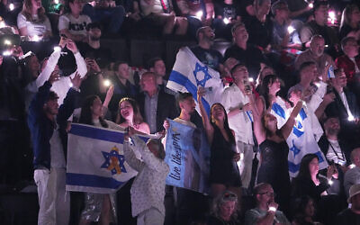 Israeli fans cheer for Yuval Raphael as she performs 'New Day Will Rise' during the second semifinal of the 69th Eurovision Song Contest, in Basel, Switzerland, May 15, 2025. (AP/Martin Meissner)