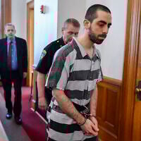 Hadi Matar walks into Chautauqua County court in Mayville, New York, where he was sentenced for 25 years in prison for the 2022 stabbing of author Salman Rushdie, May. 16, 2025. (AP Photo/Adrian Kraus)