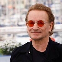 Bono poses for photographers at the photo call for the film 'Bono: Stories of Surrender' at the 78th international film festival, Cannes, southern France, on May 17, 2025. (Joel C Ryan/Invision/AP)