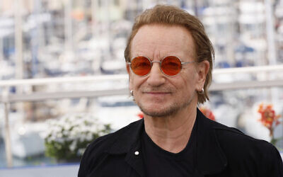 Bono poses for photographers at the photo call for the film 'Bono: Stories of Surrender' at the 78th international film festival, Cannes, southern France, on May 17, 2025. (Joel C Ryan/Invision/AP)