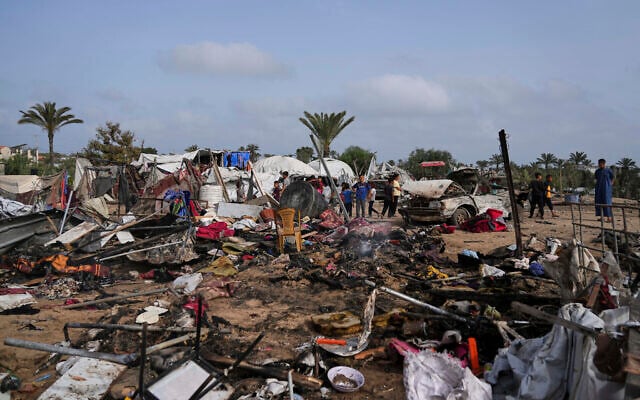 Palestinians inspect a site destroyed by Israeli airstrikes in Khan Younis, Gaza Strip, May 18, 2025. (AP Photo/Abdel Kareem Hana)