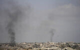 Smoke rises following an Israeli army bombardment in Khan Younis, Gaza, as seen from southern Israel, May 19, 2025. (AP Photo/Ohad Zwigenberg)