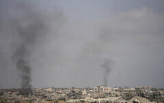 Smoke rises following an Israeli army bombardment in Khan Younis, Gaza, as seen from southern Israel, May 19, 2025. (AP Photo/Ohad Zwigenberg)
