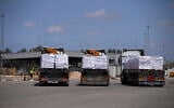 Trucks carrying humanitarian aid for the Gaza Strip are seen at the Kerem Shalom Crossing in southern Israel, May 19, 2025. (AP/Ohad Zwigenberg)