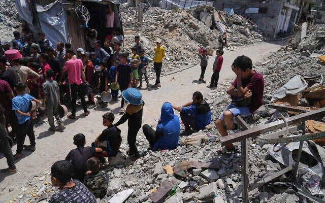 Palestinians line up for donated food at a community kitchen in Jabalia, in the northern Gaza Strip, on May 19, 2025. (AP/ Jehad Alshrafi)