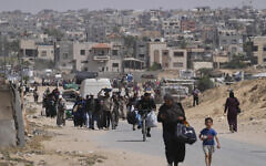 Displaced Palestinians flee from Khan Younis, Gaza, during the ongoing Israeli military offensive in the area, May 19, 2025. (AP Photo/Abdel Kareem Hana)