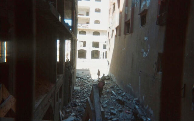 This photo provided by Breaking the Silence, a whistleblower group of former Israeli soldiers, shows two soldiers behind Palestinian detainees being sent into a Gaza City-area house to clear it in 2024. (Breaking the Silence via AP) This photo provided by Breaking the Silence, a whistleblower group of former Israeli soldiers, shows two soldiers behind Palestinian detainees being sent into a Gaza City-area house to clear it in 2024. (Breaking the Silence via AP)