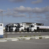 Trucks load with humanitarian aid for the Gaza Strip are seen at the Kerem Shalom Crossing in southern Israel, Tuesday May 20, 2025. (AP Photo/Maya Alleruzzo)