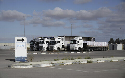 Trucks load with humanitarian aid for the Gaza Strip are seen at the Kerem Shalom Crossing in southern Israel, Tuesday May 20, 2025. (AP Photo/Maya Alleruzzo)