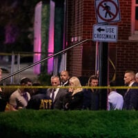 US Attorney General Pam Bondi, center, walks to her car as law enforcement work the scene after two staff members of the Israeli Embassy were shot and killed outside the Capital Jewish Museum, May 22, 2025, in Washington. (AP Photo/Rod Lamkey, Jr.)