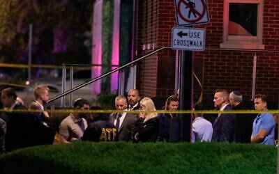 US Attorney General Pam Bondi, center, walks to her car as law enforcement work the scene after two staff members of the Israeli Embassy were shot and killed outside the Capital Jewish Museum, May 22, 2025, in Washington. (AP Photo/Rod Lamkey, Jr.)