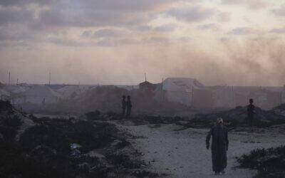 Displaced Palestinians walk through a makeshift tent camp at the Gaza City port on May 22, 2025. (AP Photo/Jehad Alshrafi)