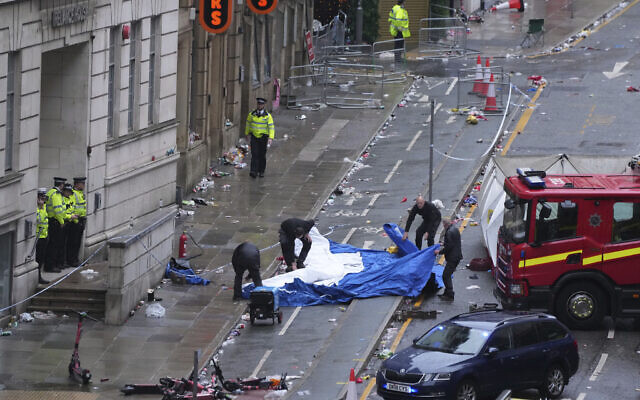 Police and emergency personnel deal with an incident after a car collided with pedestrians near the Liver Building during the Premier League winners parade in Liverpool, England, May 26, 2025.(Jon Super/AP) Police and emergency personnel deal with an incident after a car collided with pedestrians near the Liver Building during the Premier League winners parade in Liverpool, England, May 26, 2025.(Jon Super/AP)