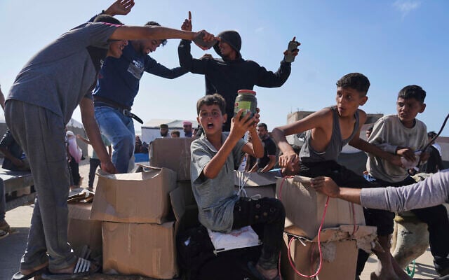 Palestinians carry boxes containing food and humanitarian aid packages delivered by the Gaza Humanitarian Foundation, a US-backed organization approved by Israel, in Rafah, southern Gaza Strip, on May 27, 2025. (AP Photo/Abdel Kareem Hana)