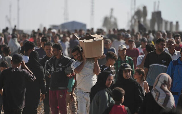 Palestinians carry boxes containing food and humanitarian aid packages delivered by the Gaza Humanitarian Foundation, a US-backed organization approved by Israel, in Rafah, southern Gaza Strip, May 27, 2025. (AP Photo/Abdel Kareem Hana)