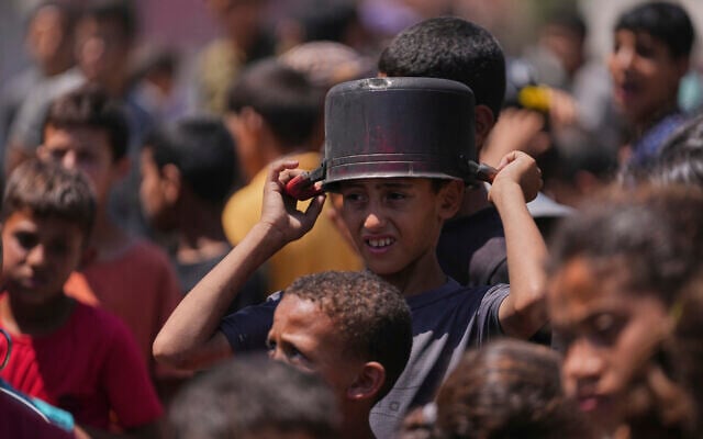 A young Palestinian waits to collect donated food at a food distribution kitchen in Deir al-Balah, Gaza Strip, Friday, May 30, 2025. (AP Photo/Abdel Kareem Hana) A young Palestinian waits to collect donated food at a food distribution kitchen in Deir al-Balah, Gaza Strip, Friday, May 30, 2025. (AP Photo/Abdel Kareem Hana)