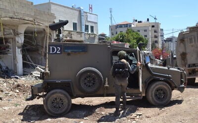 A Border Police officer enters an armored vehicle in Jenin refugee camp in the northern West Bank, April 7, 2025. (Stav Levaton/Times of Israel)