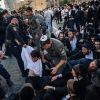 Haredi Jews protest and clash with police during a protest against the drafting of ultra-Orthodox Jews to the Israeli army, Jerusalem, May 5, 2025. (Chaim Goldberg/Flash90)