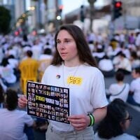 Protesters dressed in white attend a silent protest calling for the release of Israelis held hostage in the Gaza Strip, outside the Defense Ministry in Tel Aviv on May 11, 2025. (Tomer Neuberg/Flash90)