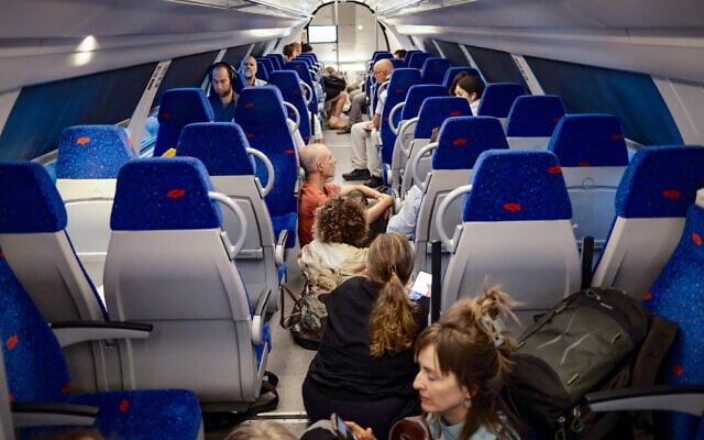 People take cover as a siren warns of an incoming missile fired from Yemen, on a train in Jerusalem, May 13, 2025. (Dor Pazuelo/Flash90)
