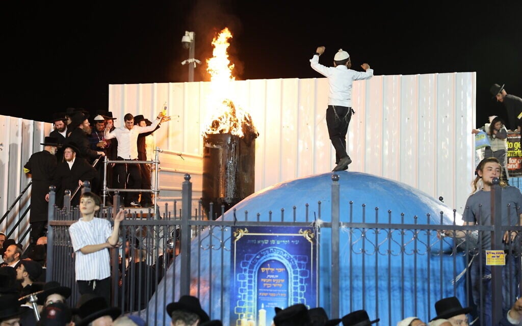 The Grand Rabbi of the Boyan Hasidic dynasty lights the bonfire during Lag B'Omer celebrations, in Mount Meron, northern Israel, May 15, 2025 (David Cohen/Flash90)