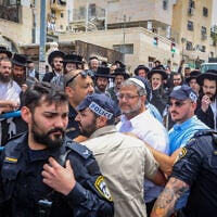 Ultra-Orthodox residents of Beit Shemesh protest against National Security Minister Itamar Ben-Gvir and his wife Ayala, May 15, 2025. (Yaakov Lederman/Flash90)