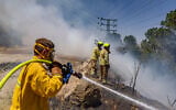 Illustrative: Firefighters battle blazes in Jerusalem, May 16, 2025. (Chaim Goldberg/Flash90)
