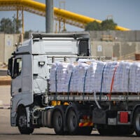 Trucks with loaded with humanitarian aid seen before entering the Gaza Strip, on the Israeli side of the border with Gaza, May 19, 2025. (Flash90)