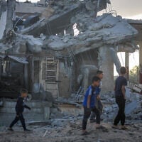 Palestinians at the site of an Israeli airstrike at a gas station and tents, in the Nuseirat refugee camp, in the central Gaza Strip, on May 20, 2025. (Ali Hassan/Flash90)