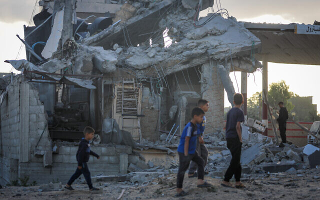 Palestinians at the site of an Israeli airstrike at a gas station and tents, in the Nuseirat refugee camp, in the central Gaza Strip, on May 20, 2025. (Ali Hassan/Flash90) Palestinians at the site of an Israeli airstrike at a gas station and tents, in the Nuseirat refugee camp, in the central Gaza Strip, on May 20, 2025. (Ali Hassan/Flash90)