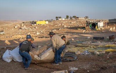 Palestinian residents of Maghar al-Deir pack up belongings as they flee the West Bank village on May 22, 2025.  (Chaim Goldberg/Flash90)