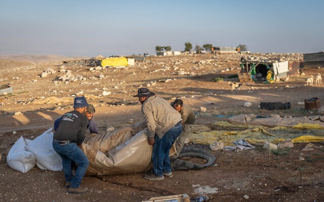 Palestinian residents of Maghar al-Deir pack up belongings as they flee the West Bank village on May 22, 2025.  (Chaim Goldberg/Flash90)
