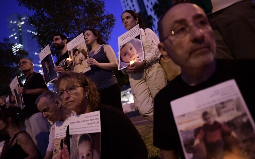 Activists hold up photos of children killed during the war in Gaza, during a protest calling to end the war, in Tel Aviv, May 24, 2025. (Tomer Neuberg/Flash90)