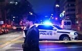 A man, standing behind police tape, talks on his cell phone outside the Capital Jewish Museum following a shooting that killed two people, in Washington, DC, in the early hours of May 22, 2025. (Alex Wroblewski/AFP via Getty Images via JTA)