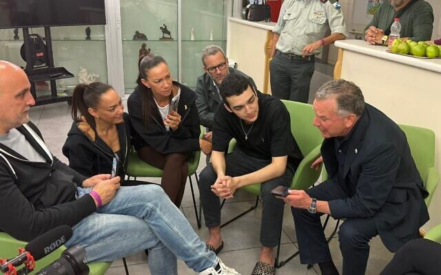 US Special Envoy Steve Witkoff, right, and freed hostage Edan Alexander, second right, speak by phone to US President Donald Trump, alongside Alexander's family from Tel Aviv Sourasky Medical Center on May 13, 2025. (Office of the Special Envoy to the Middle East/X)