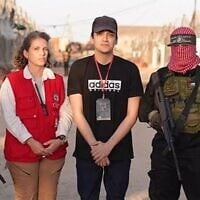 Freed hostage Edan Alexander with a representative of the Red Cross, flanked by Hamas gunmen in the Gaza Strip on May 12, 2025. (via Al Jazeera)