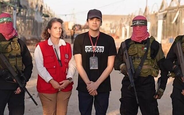 Freed hostage Edan Alexander with a representative of the Red Cross, flanked by Hamas gunmen in the Gaza Strip on May 12, 2025. (via Al Jazeera)